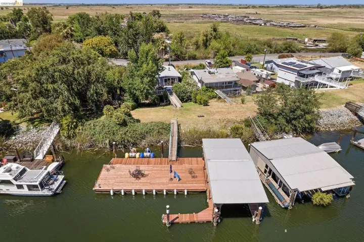 Waterfront property featuring a private boat dock, two covered boat slips, and direct water access
