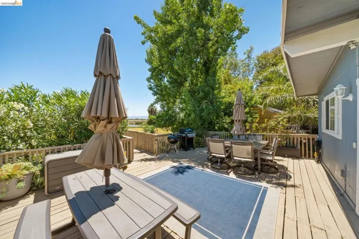 Spacious outdoor deck featuring wood flooring, a perimeter railing, and exterior wall siding