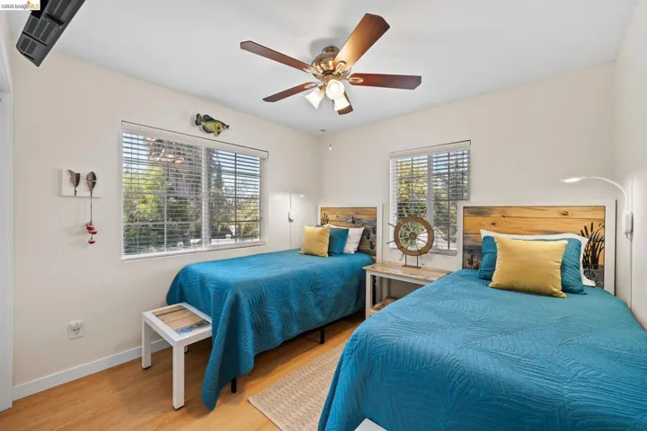 Wood-finish flooring with a ceiling fan overhead