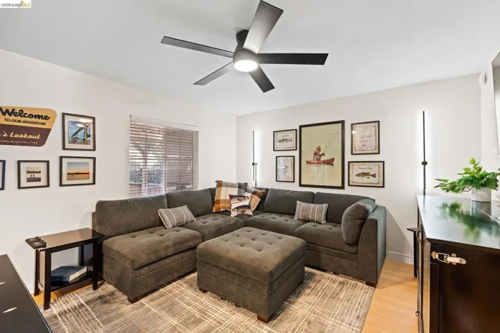 Interior living space featuring light wood-finish flooring and a contemporary ceiling fan