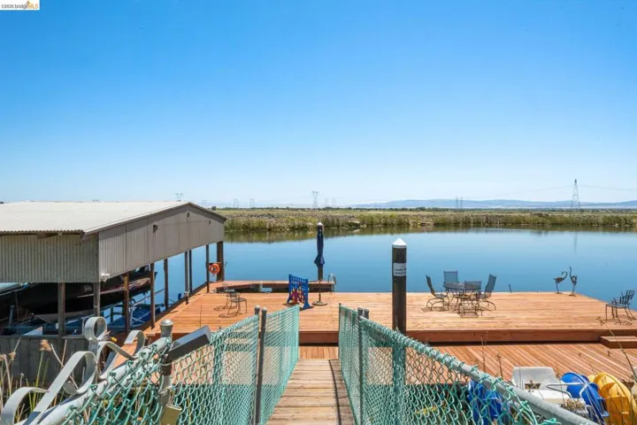 Private dock featuring a spacious wood-finish deck