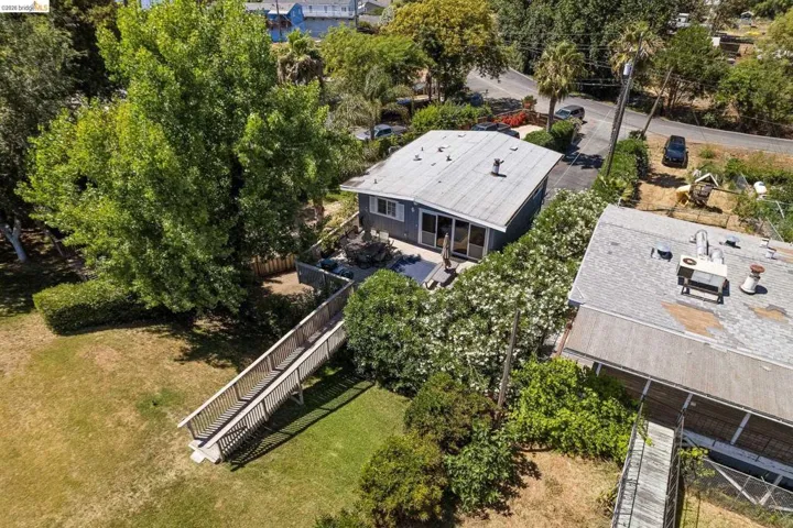 Aerial perspective showcasing a single-story dwelling with a light-colored roof