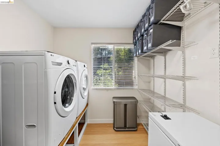 Dedicated utility space with wood-finish flooring
