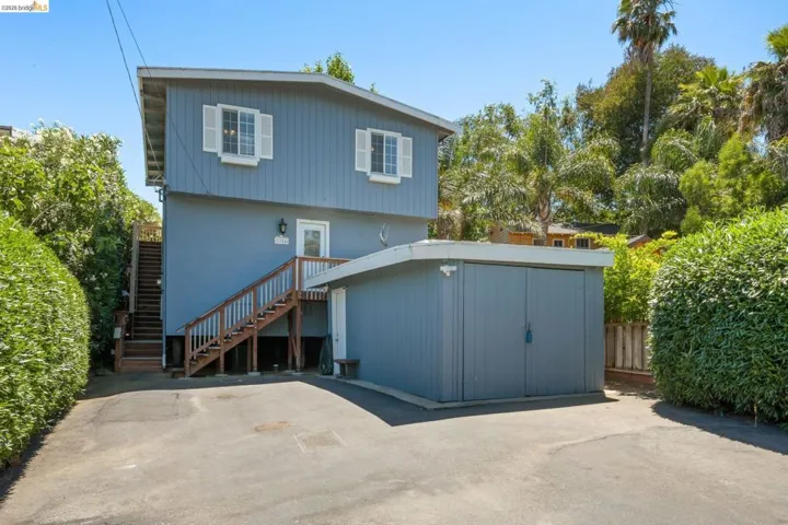 Two-story residence featuring light blue siding and white window shutters
