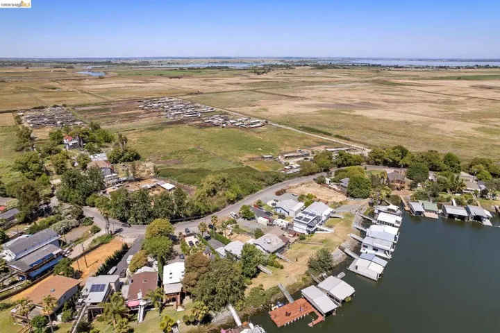 Aerial perspective showcasing waterfront properties with private docks and covered boat slips