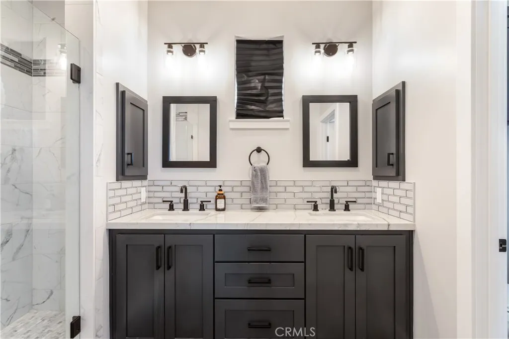 Primary bath with 2 sinks and walk in shower.