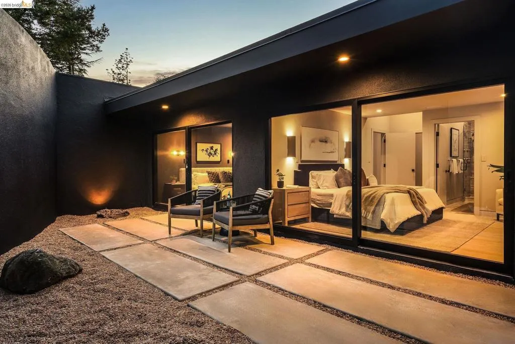 Private courtyard featuring a gravel ground cover and concrete paver pathway