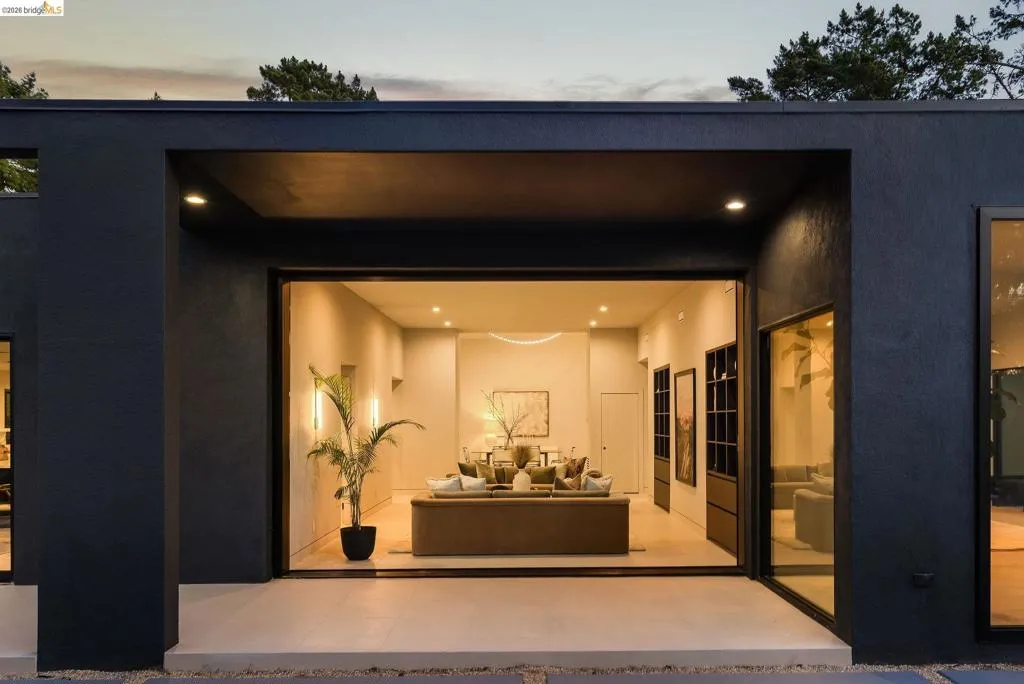 Modern exterior with dark-toned stucco finish and recessed lighting