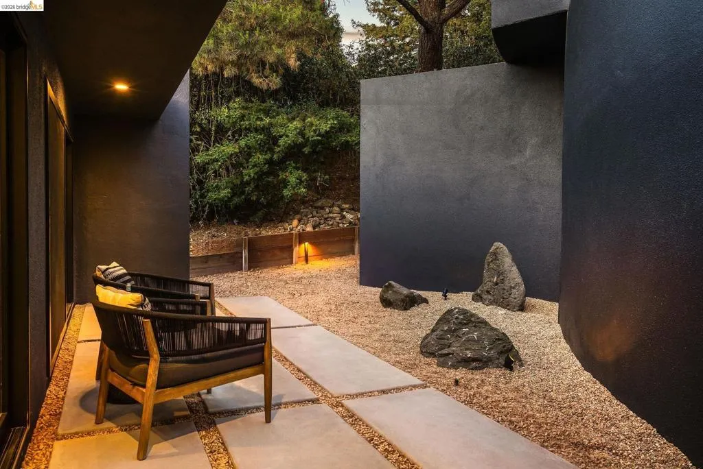 Outdoor patio area featuring large format paver stones set in gravel