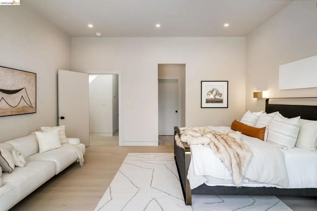 Spacious room featuring light wood-finish flooring, recessed lighting, and a neutral color palette