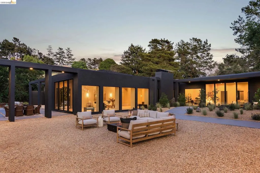 Modern exterior with dark-toned siding and extensive glass panels