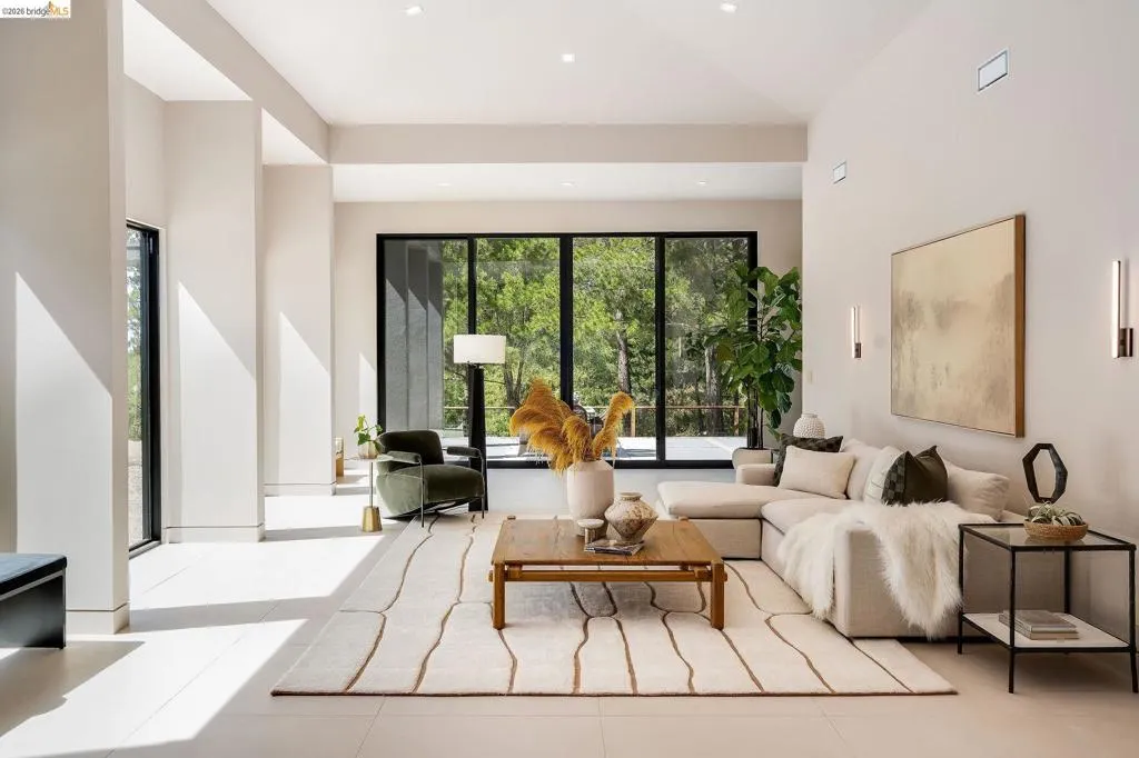 Great room featuring vaulted ceilings, recessed lighting, and expansive windows