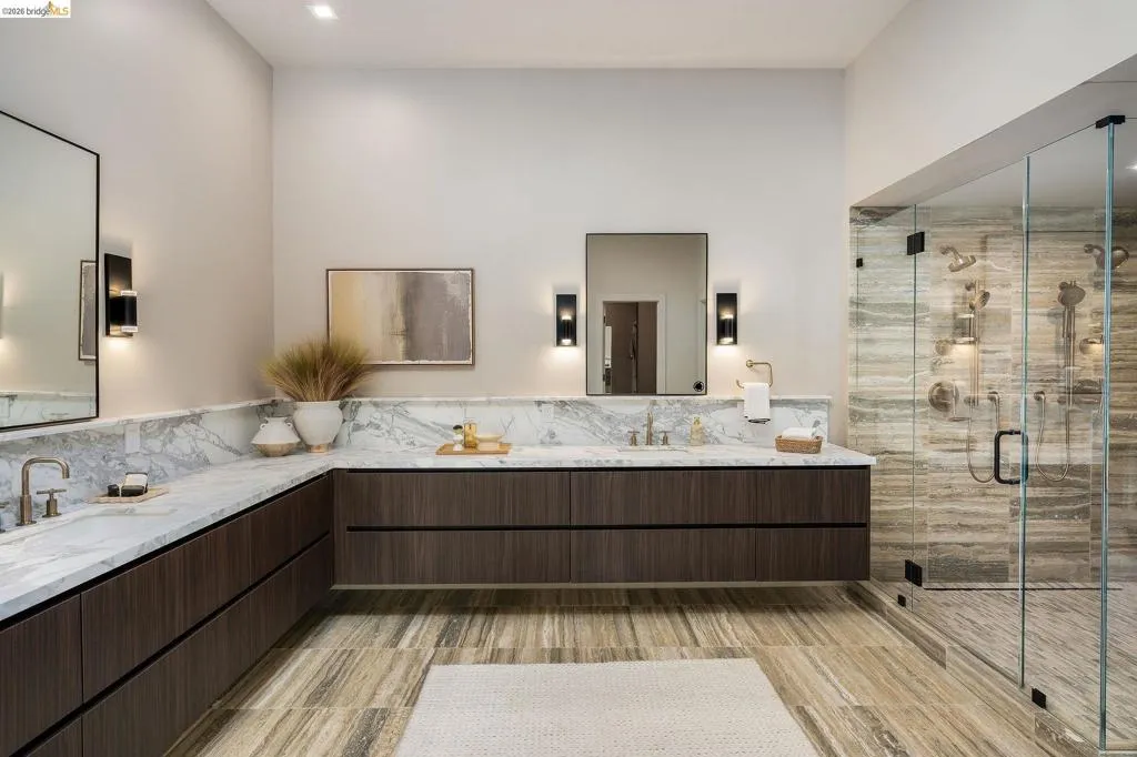 Spacious bathroom featuring a dual vanity with stone countertops and dark wood-finish cabinetry