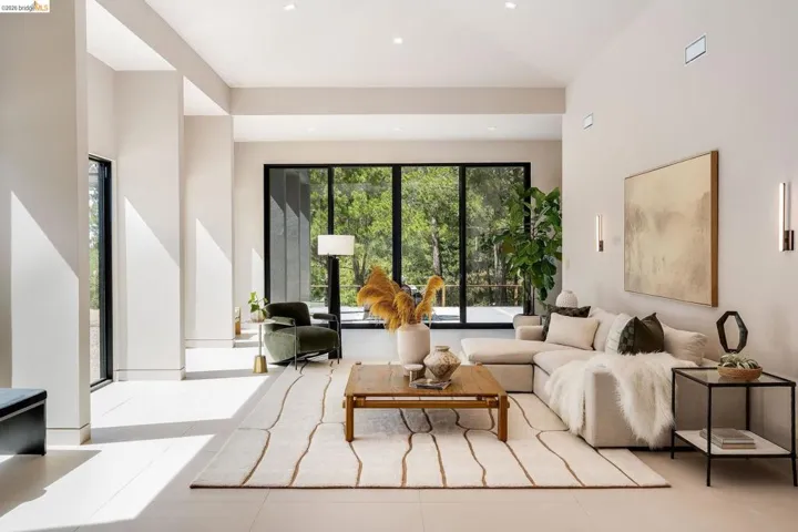 Great room featuring vaulted ceilings, recessed lighting, and expansive windows
