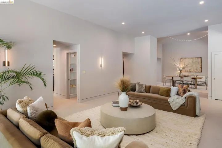 Spacious living area featuring neutral wall tones and recessed lighting