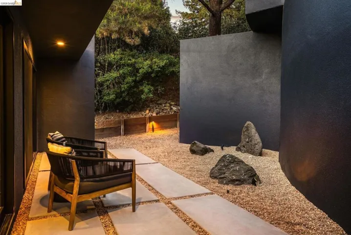 Outdoor patio area featuring large format paver stones set in gravel