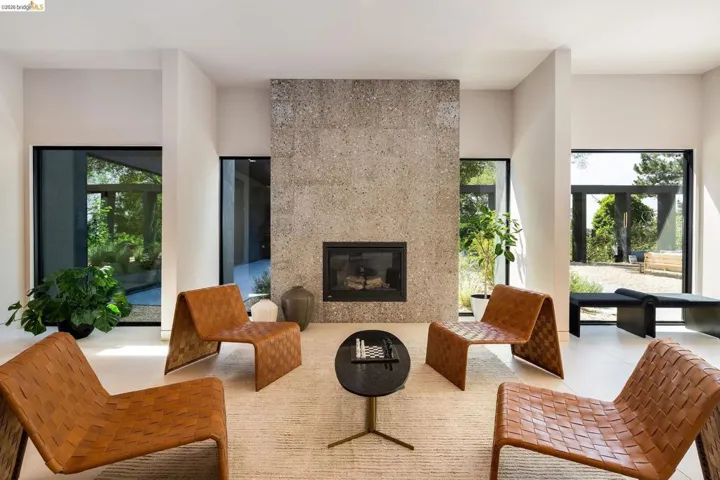 Integrated fireplace featuring a textured stone facade