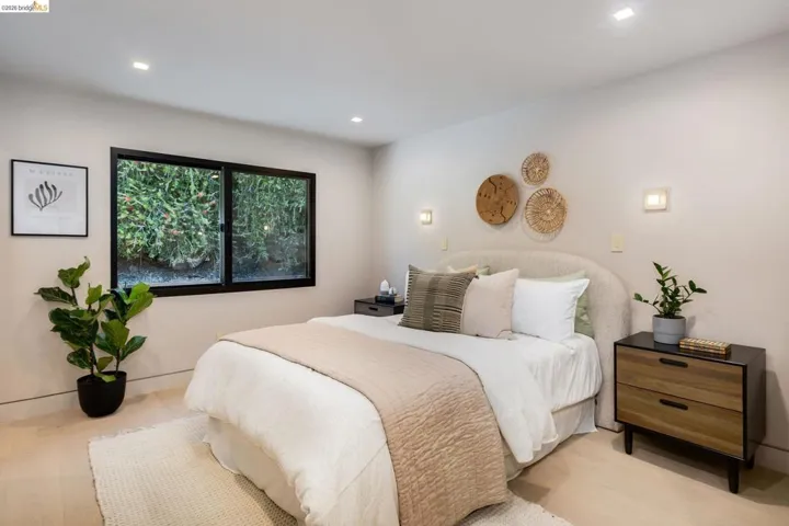 Recessed ceiling lighting illuminates light-toned walls and wood-finish flooring