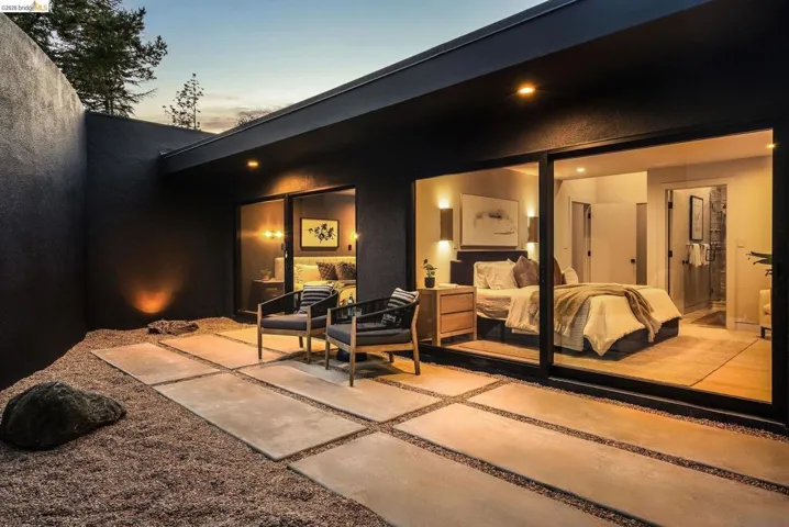 Private courtyard featuring a gravel ground cover and concrete paver pathway