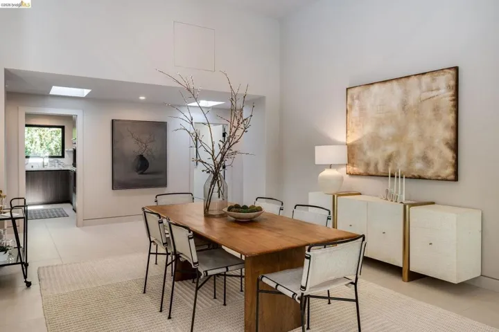 Spacious dining area featuring high ceilings, recessed lighting, and skylights