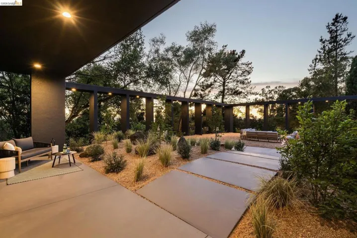 Expansive outdoor patio area featuring a covered section with recessed lighting