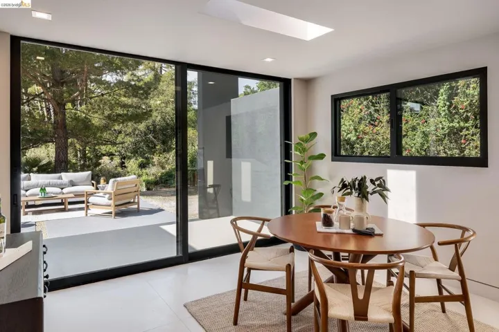 Dining area featuring large sliding glass doors, a skylight, and recessed lighting