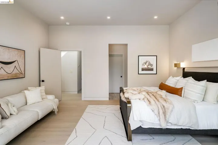 Spacious room featuring light wood-finish flooring, recessed lighting, and a neutral color palette