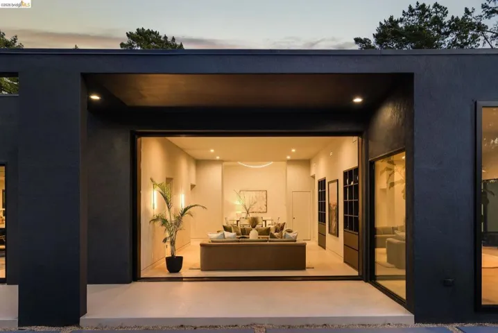 Modern exterior with dark-toned stucco finish and recessed lighting