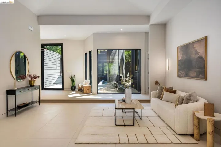 Spacious interior with high ceilings and light-toned tile flooring
