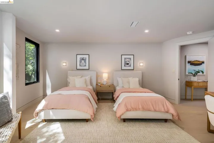 Spacious room featuring light wood-finish flooring, recessed lighting, and a large window with black trim