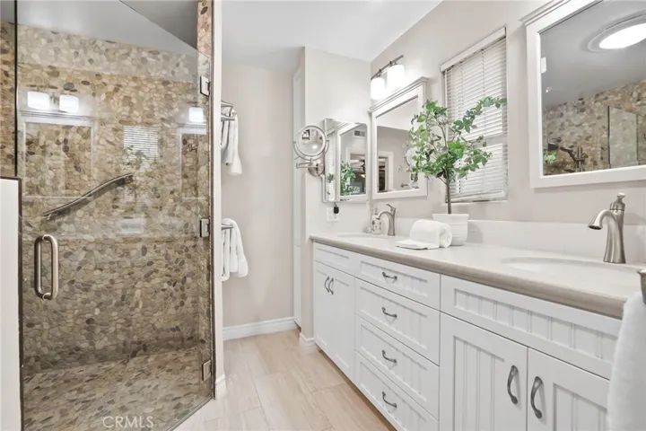 Primary bath with step in shower, double sinks and heated floors.