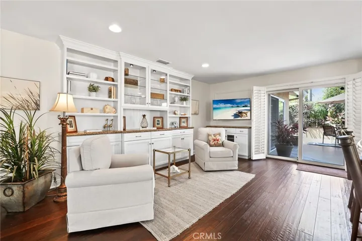 Seating and tv area off the  kitchen with built in cabinetry.