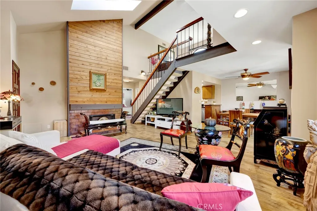 Bright and spacious living area with dramatic loft-style ceilings, abundant light, and a warm, inviting atmosphere.