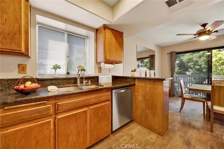 Practical kitchen layout with generous cabinet space, full-size appliances, and warm wood finishes.