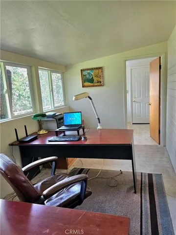 Office area, bright and light, peaceful pacyard view.