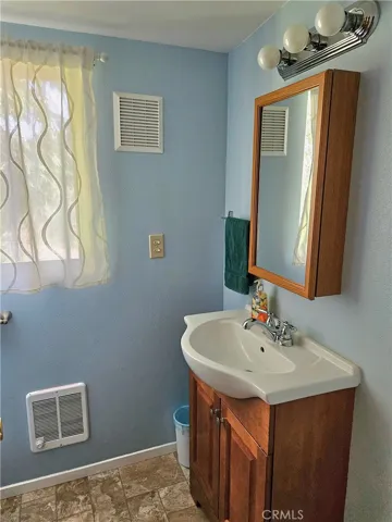 Bathroom #2 features a beautifully tiled shower as the primary bathing amenity, with the absence of a traditional bathtub. Additionally, this bathroom boasts a newly installed, energy-efficient dual-pane window for enhanced natural light and improved insulation.