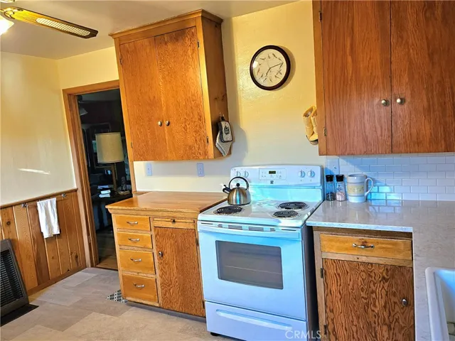 Flooring is in great condition. Pinewood paneling. Door goes into living room.