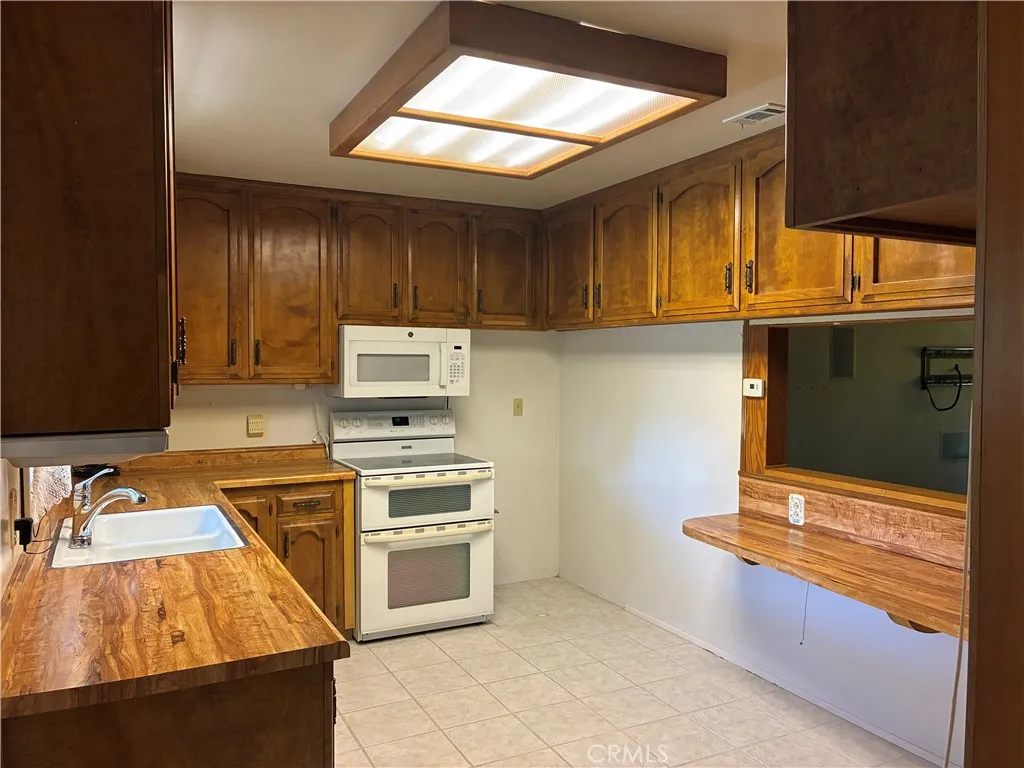 Kitchen has much cabinet space, wrap around bar open to the dining area and living rm.
