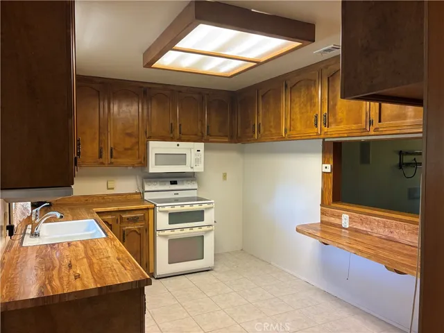 Kitchen has much cabinet space, wrap around bar open to the dining area and living rm.