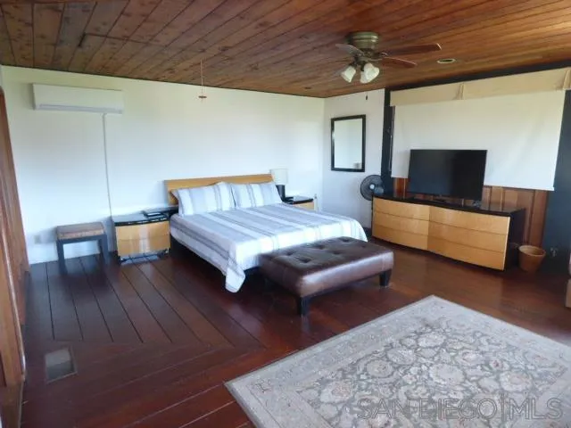 Upstairs bedroom with balcony and peak view of ocean
