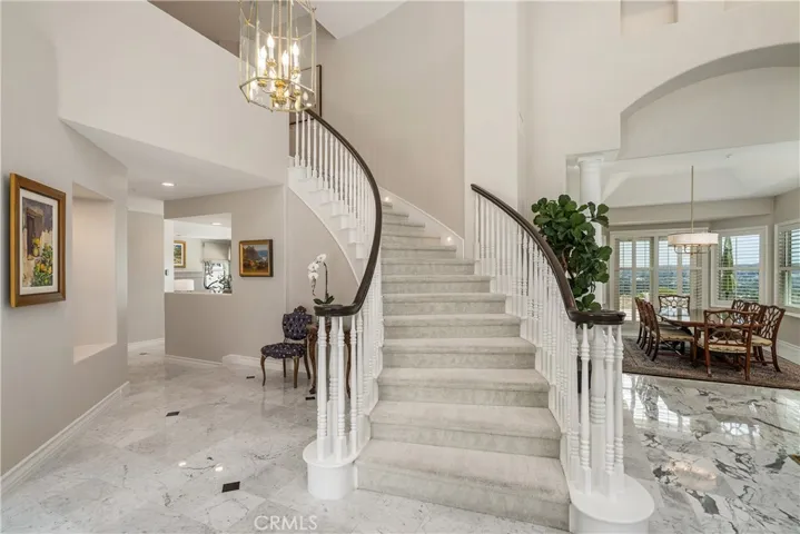 Grand sweeping staircase at the entry.Entry view of Living Room