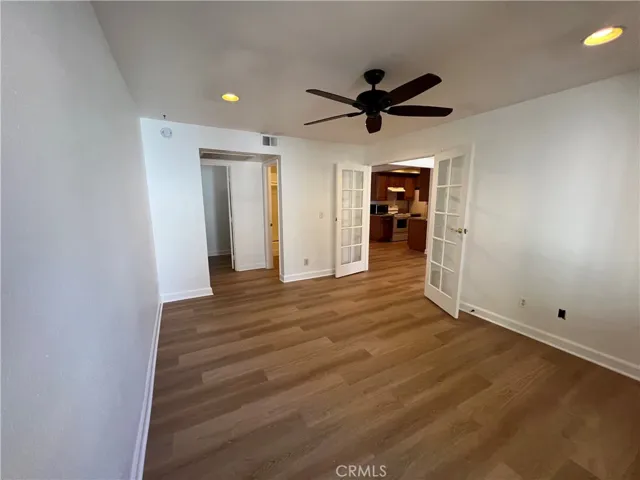 Bedroom  looking at entrance to walk in closet & bathroom and then double doors entrance to living room.