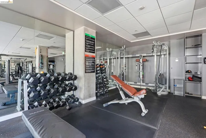 Fitness center featuring extensive mirrored walls and rubberized flooring