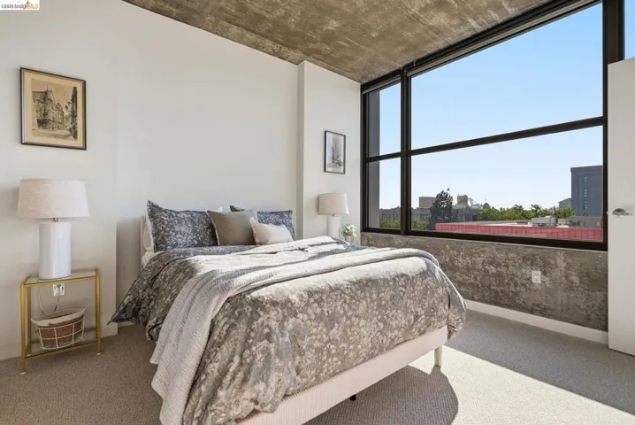 Full-height window with dark framing and a concrete accent wall
