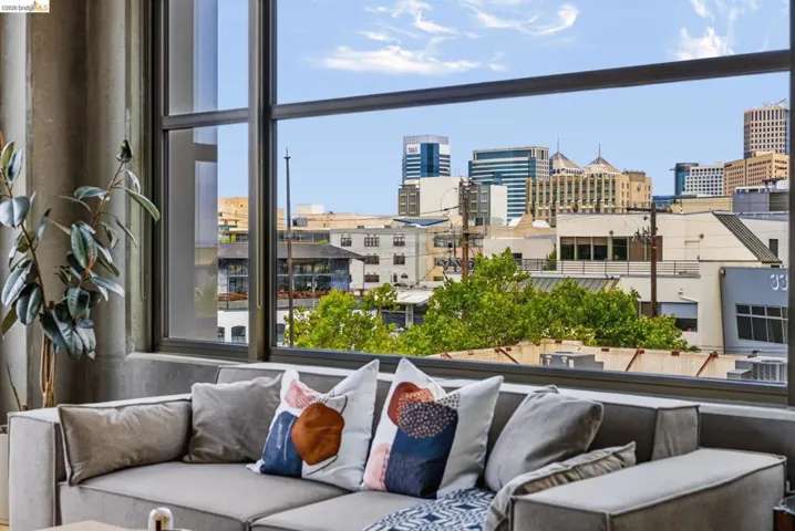 Expansive window with dark framing capturing cityscape and sky