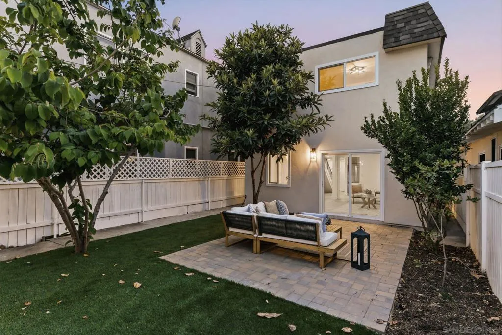 The back yard and patio split the two homes. Fruit trees, fully and privately fenced.  Beautiful space!
