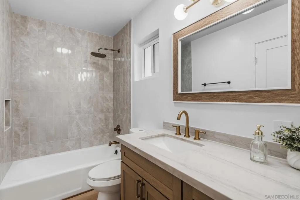 Second full bathroom upstairs serves the secondary bedrooms.  Tub in shower, brand new tile and brand new vanity, counters and fixtures.