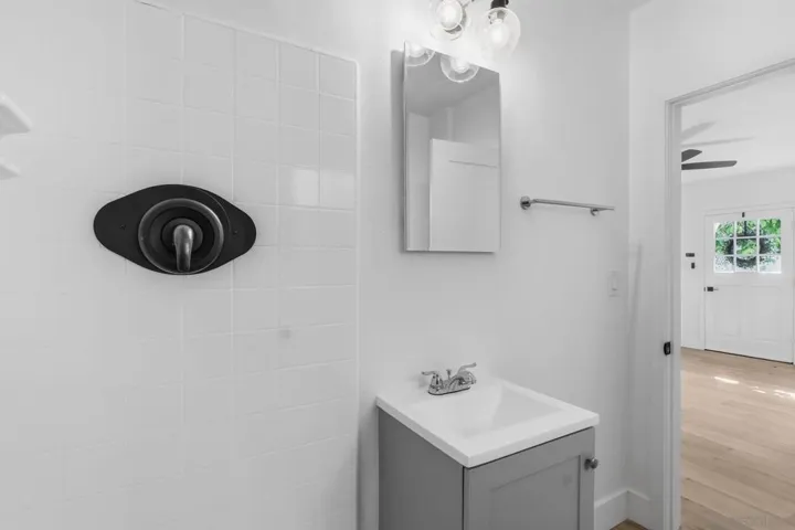 ADU Bathroom features a tub in shower. Room for a storage cabinet, if desired.