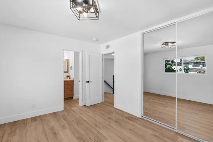 Spacious bedrooms in the main house.  This one can be considered a second primary bedroom.  It adjoins the second full bath upstairs.  Mirrored closet doors and brand new windows.