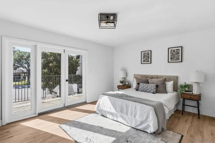Gorgeous primary bedroom!  West-facing with a balcony and a vanity.  A beautiful primary bath was just added to the primary suite.
